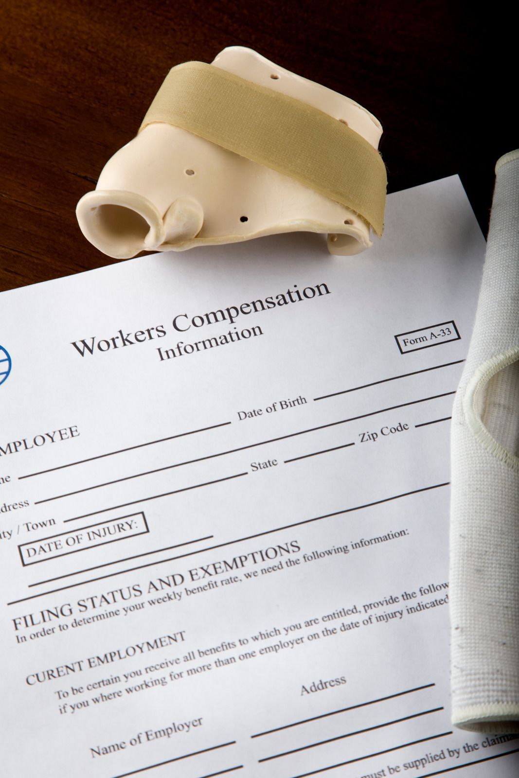 Workers' compensation form with a wrist brace, suggesting a workplace injury.