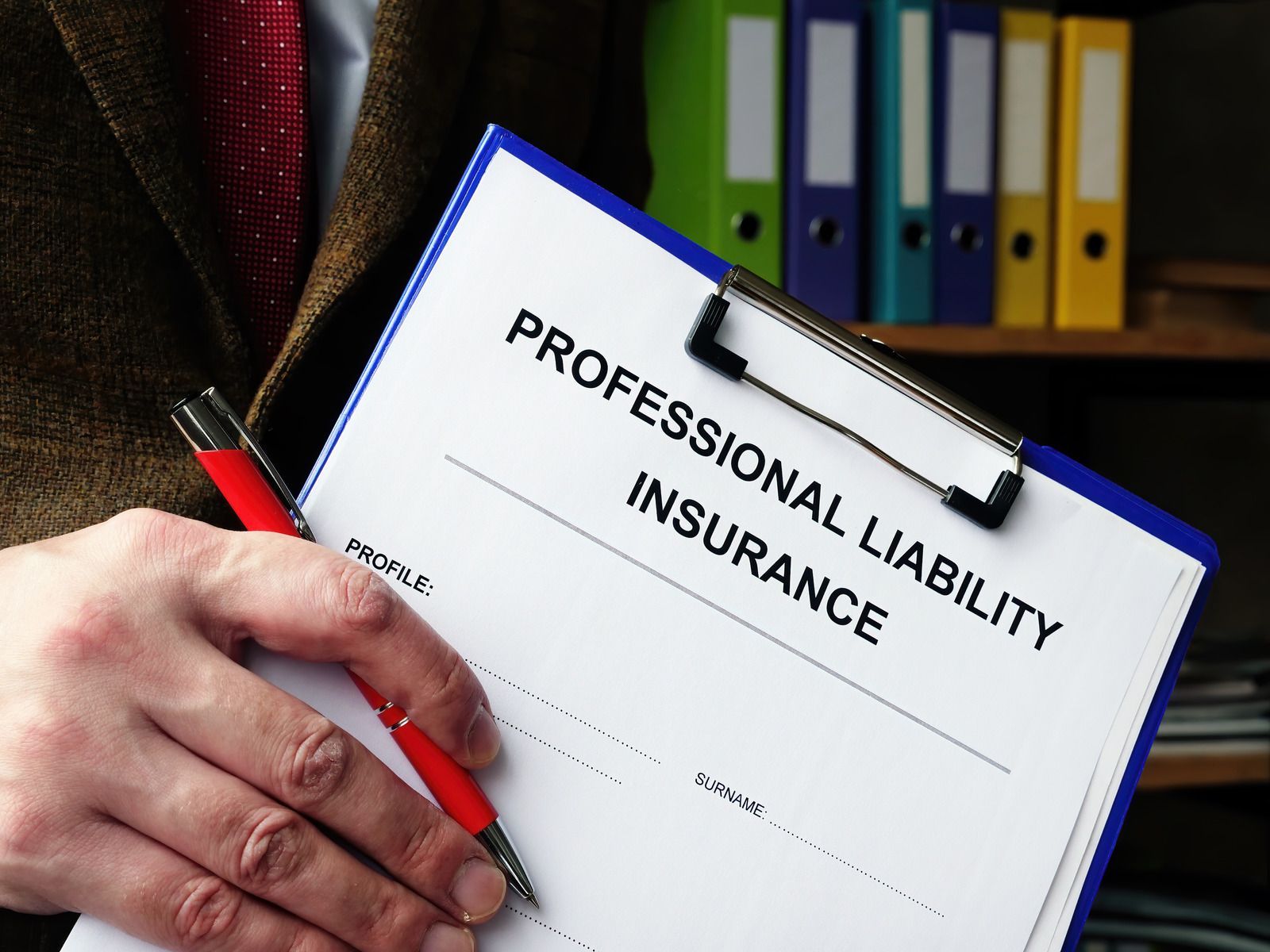 Person in suit holds clipboard with