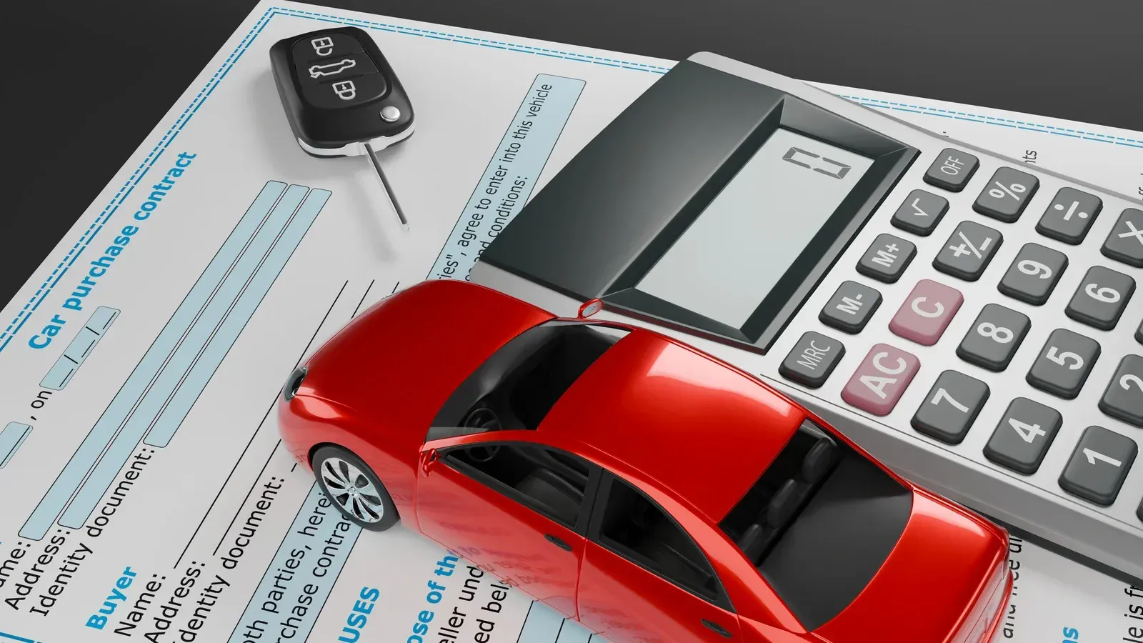 Red toy car, car keys, and calculator on top of a car purchase document.