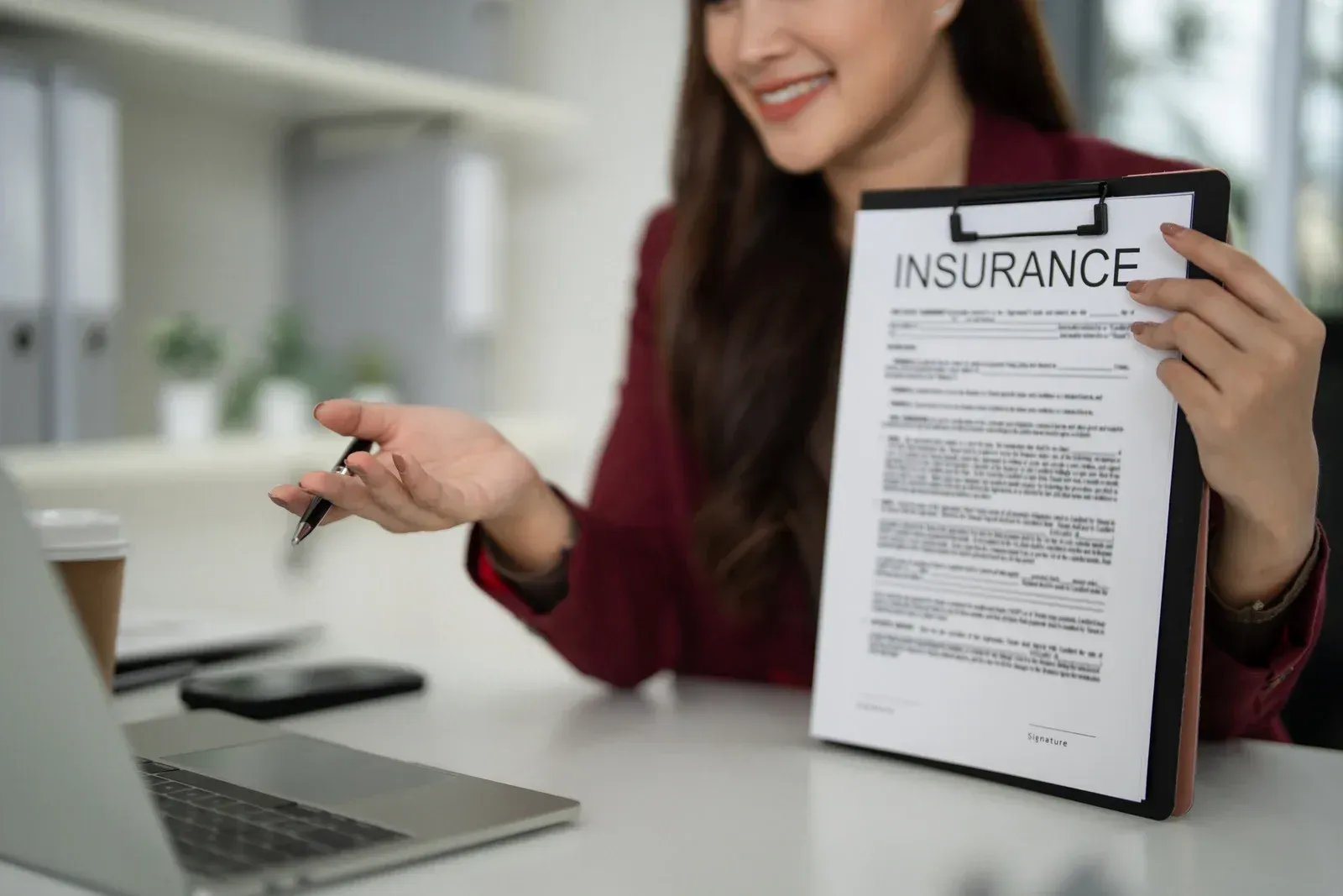 Hands cupping a cardboard house, symbolizing protection and home security.