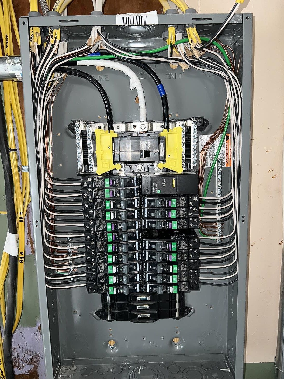 Electric switchboard with various switches and circuit breakers.