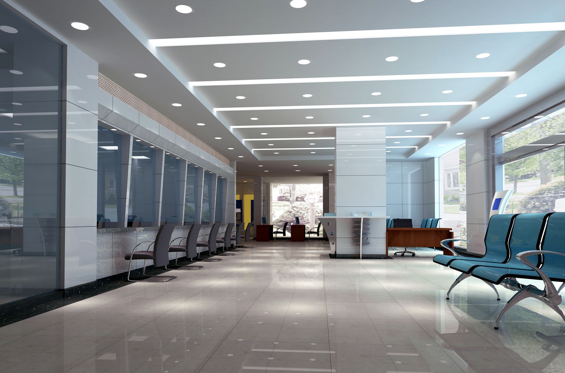 Recessed lighting illuminates an office reception area with counters and seating areas.