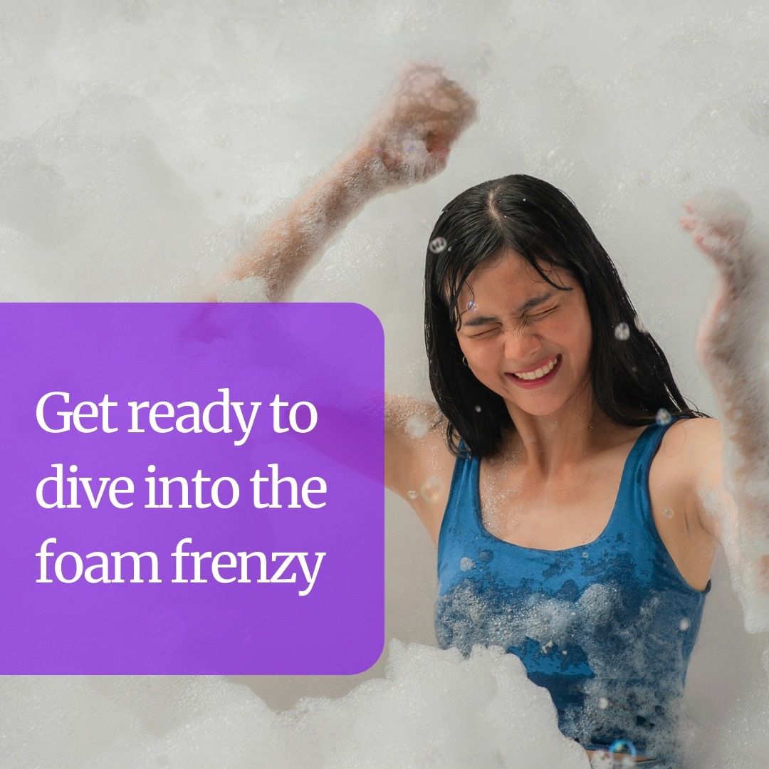 A woman is in a bathtub with foam and says get ready to dive into the foam frenzy