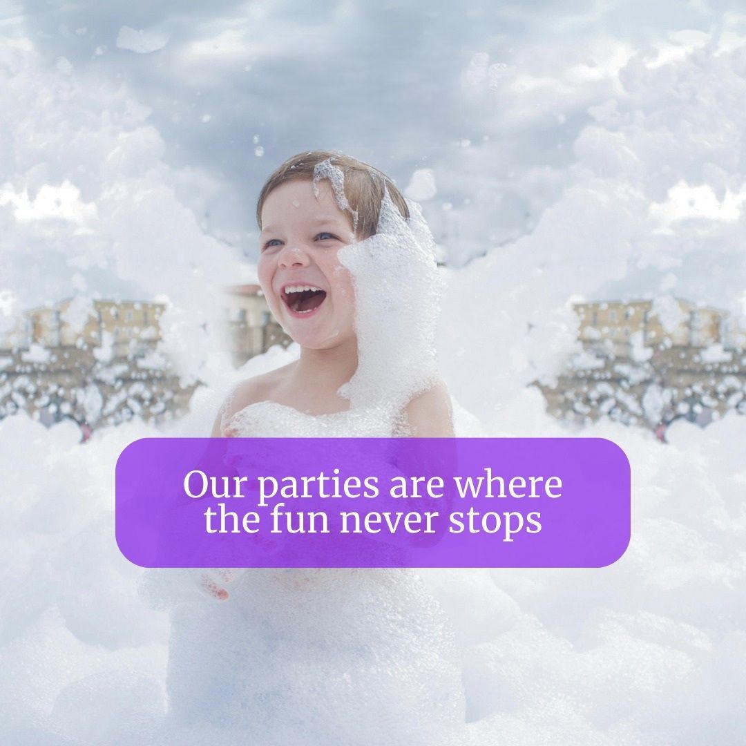 A little girl is playing in foam with a purple sign that says our parties are where the fun never stops