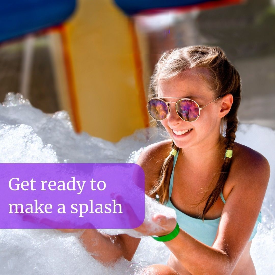A girl wearing sunglasses is sitting in a pool of foam