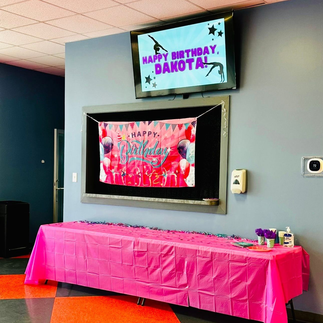 A happy birthday dakota sign hangs above a table