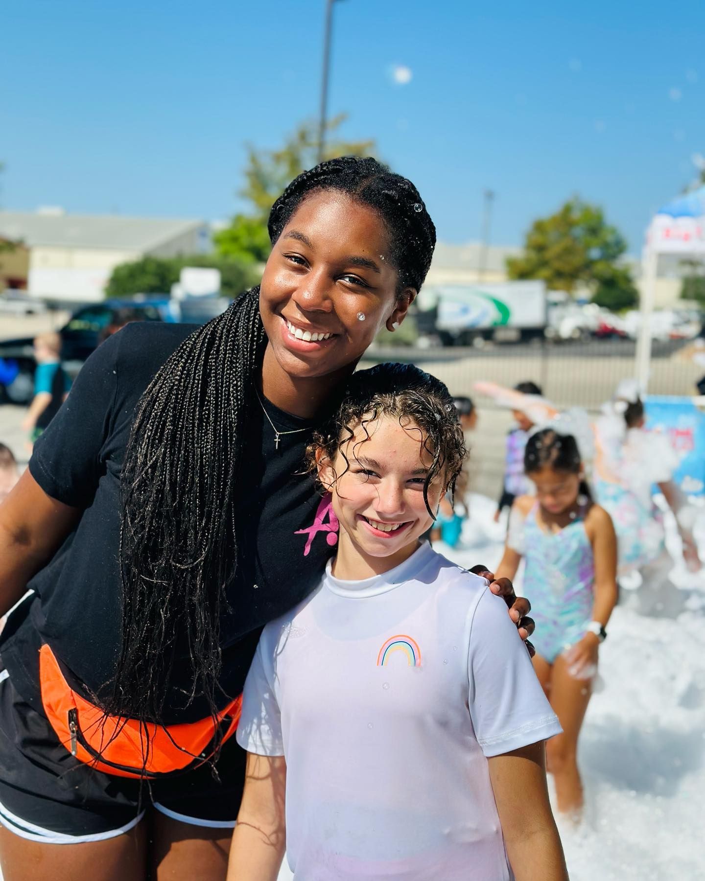 A woman and a little girl are posing for a picture.