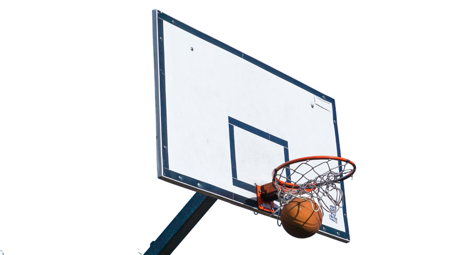 Basketball going through a hoop attached to a white backboard with a blue trim, set against a white sky.