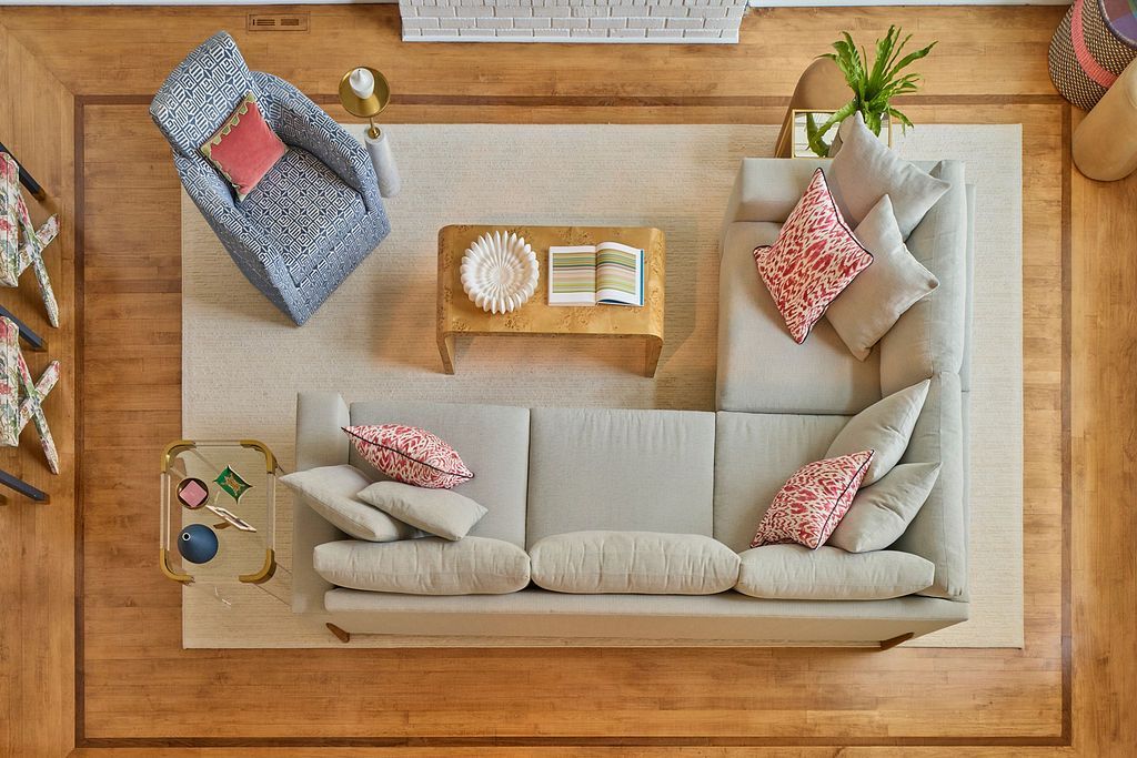 Overhead view of living room with a sectional sofa, armchair, coffee table, and area rug.