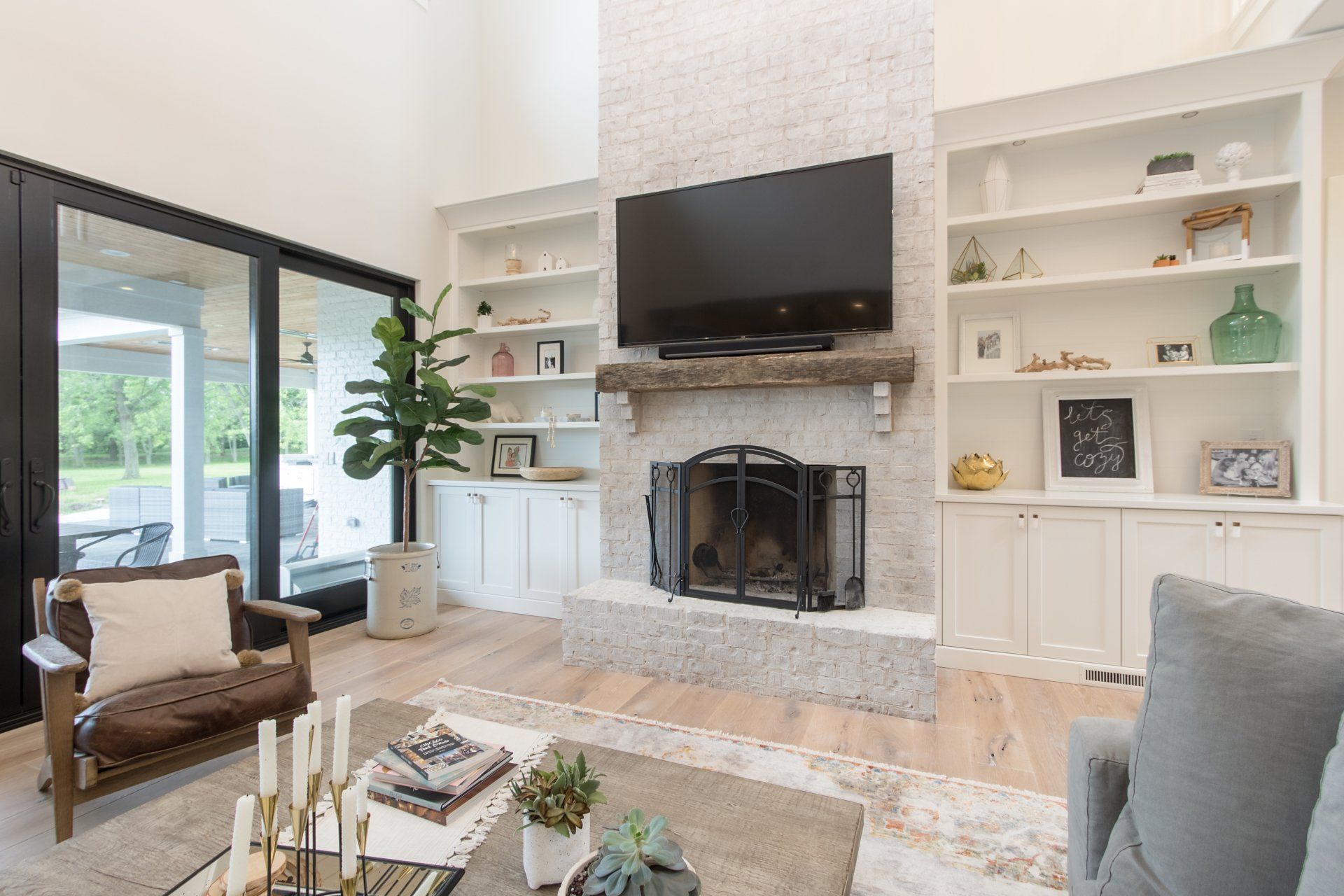 A living room with a fireplace and a flat screen tv.