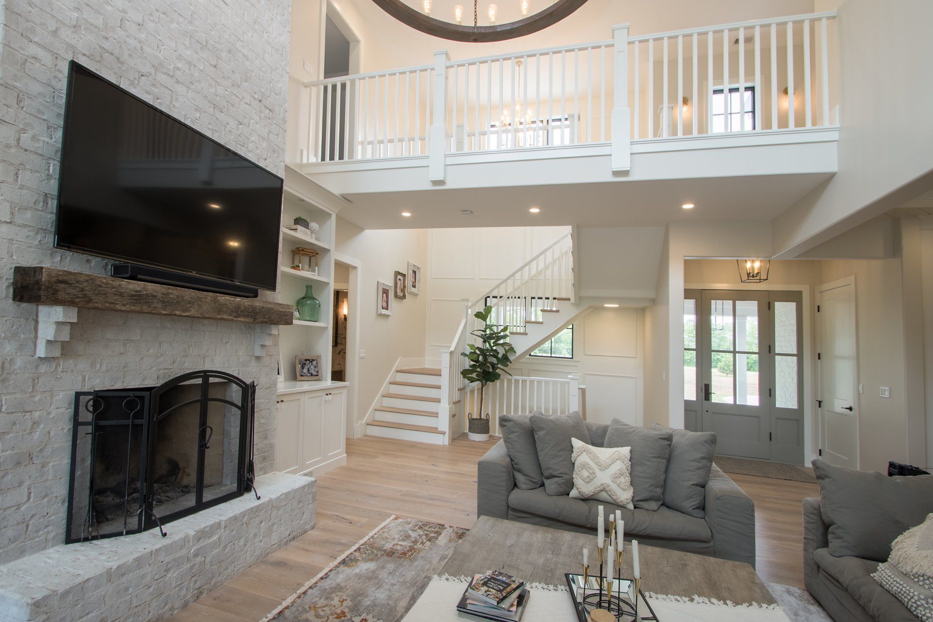A living room with a fireplace and a flat screen tv.