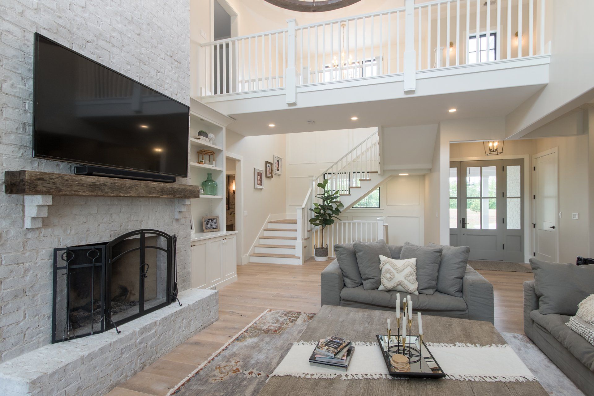 A living room with a fireplace and a flat screen tv.