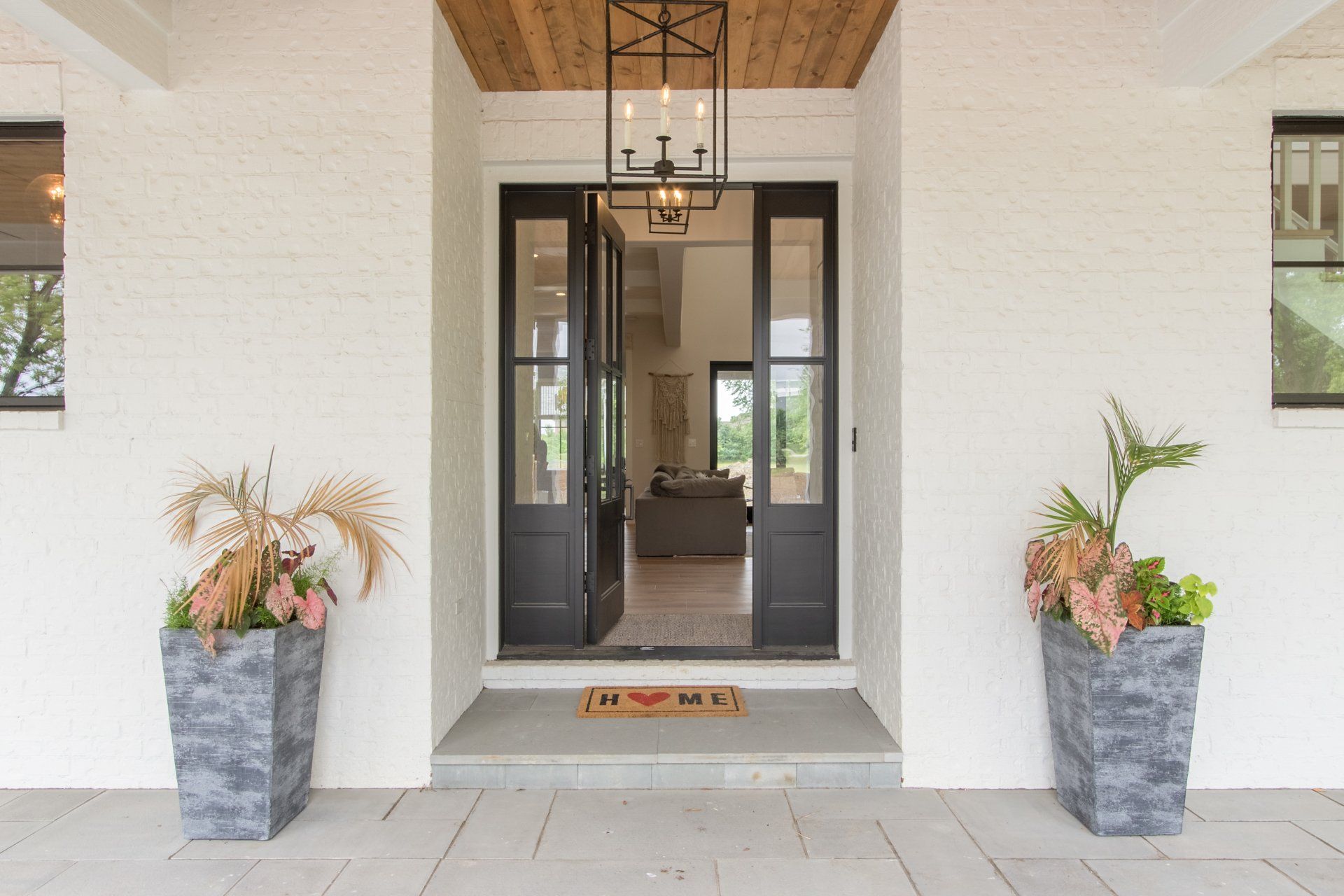 The front door of a house with two potted plants in front of it