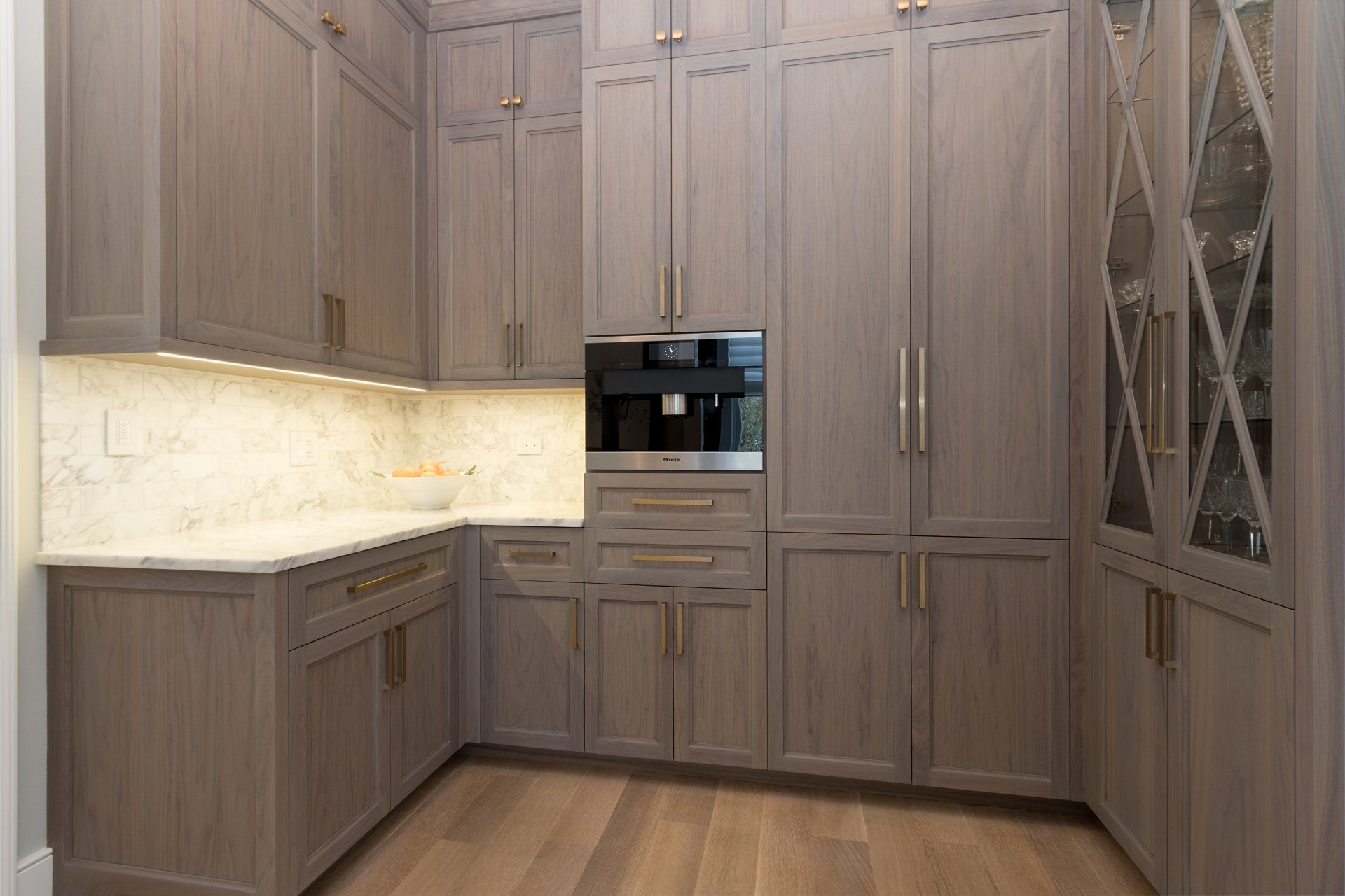 A kitchen with a lot of cabinets and a refrigerator.