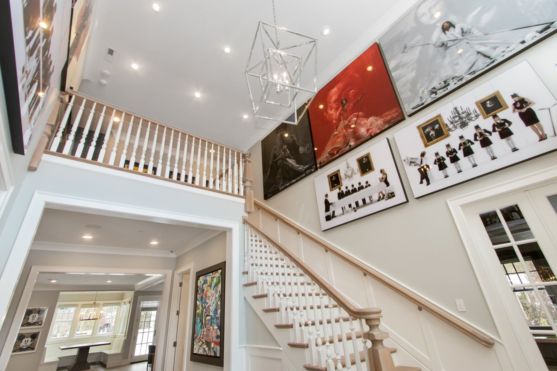 A staircase in a house with a lot of paintings on the wall.