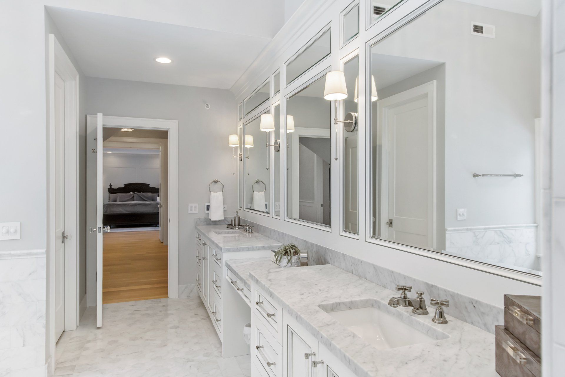 A bathroom with two sinks and two mirrors.