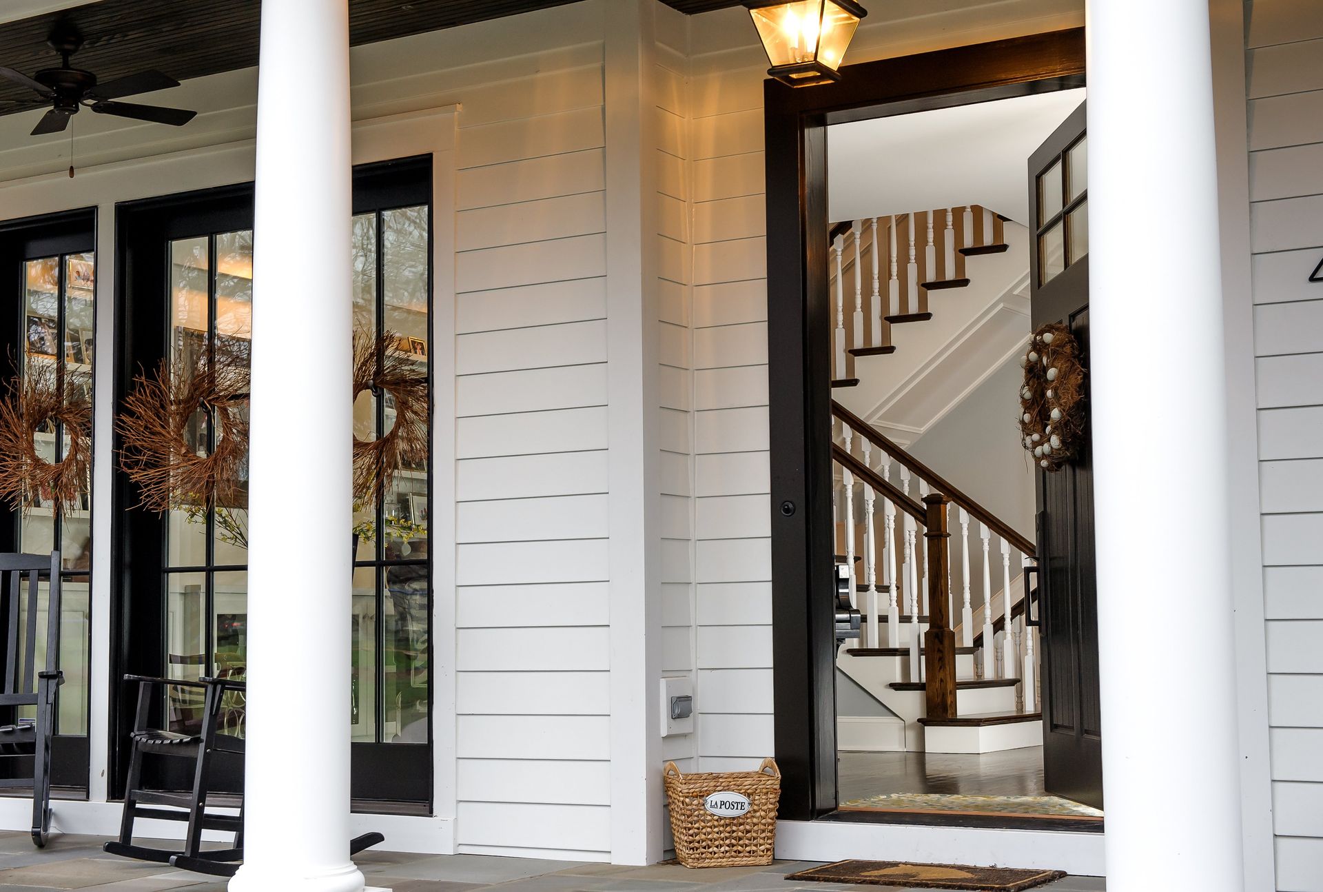 A white house with a black door and stairs