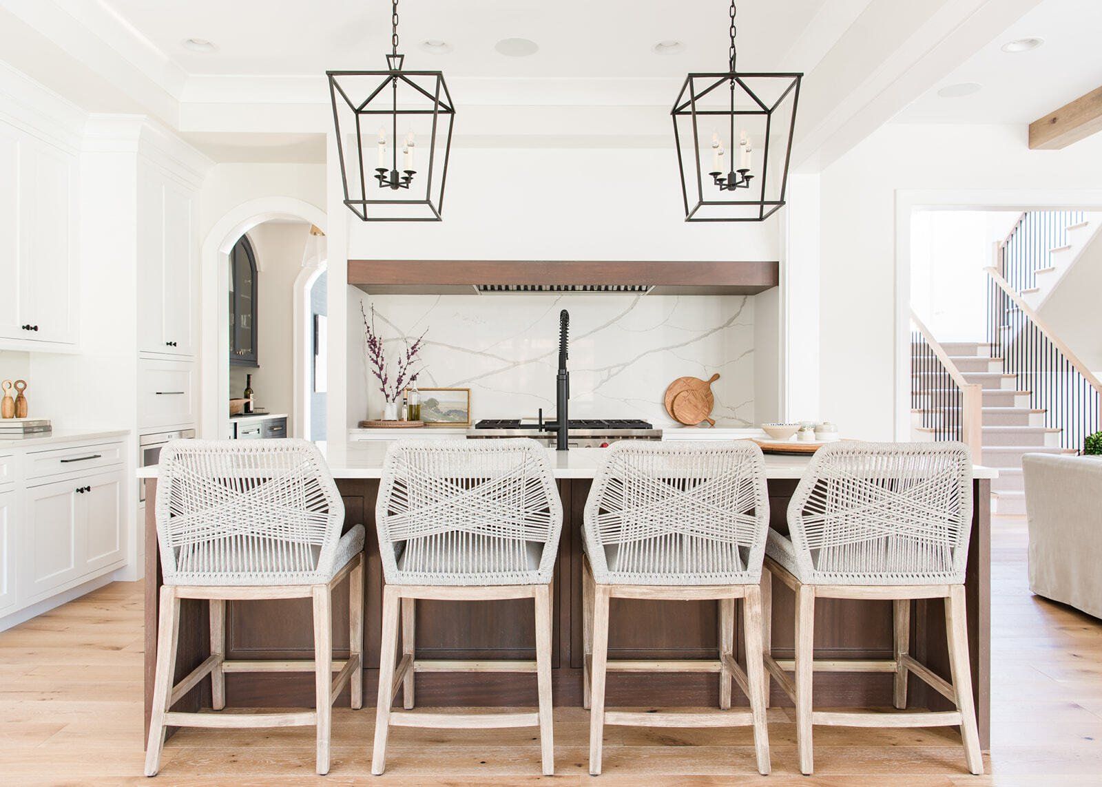 A kitchen with a large island and stools