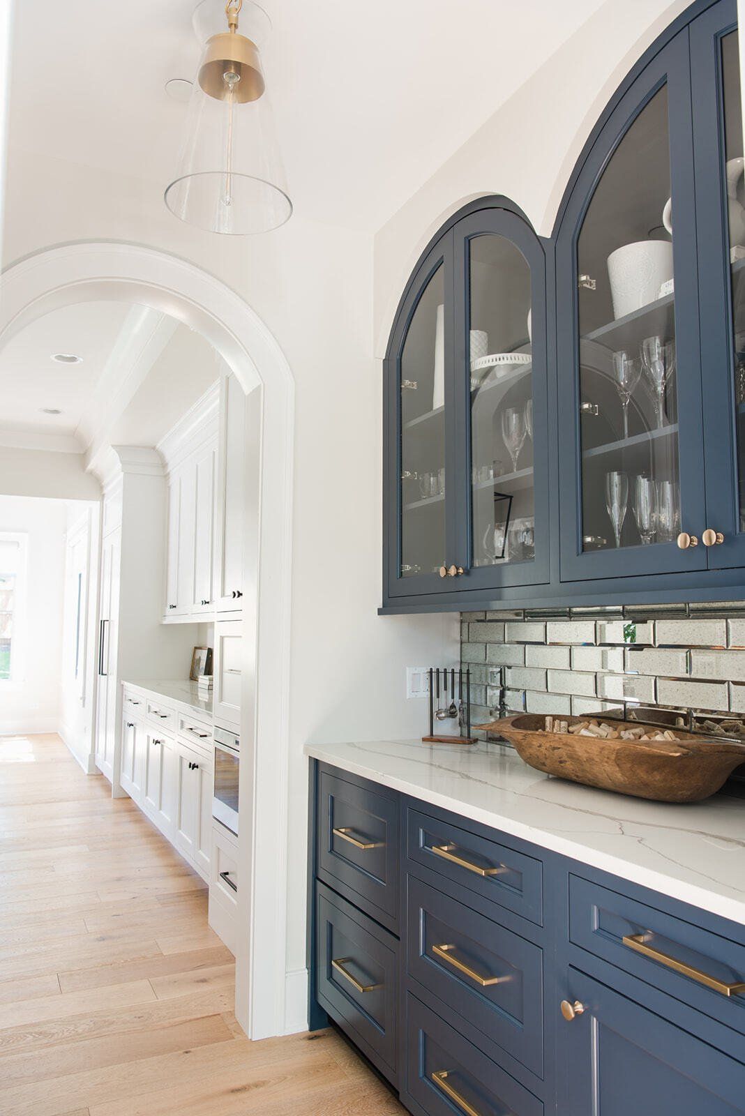 A kitchen with blue cabinets and a bowl on the counter.