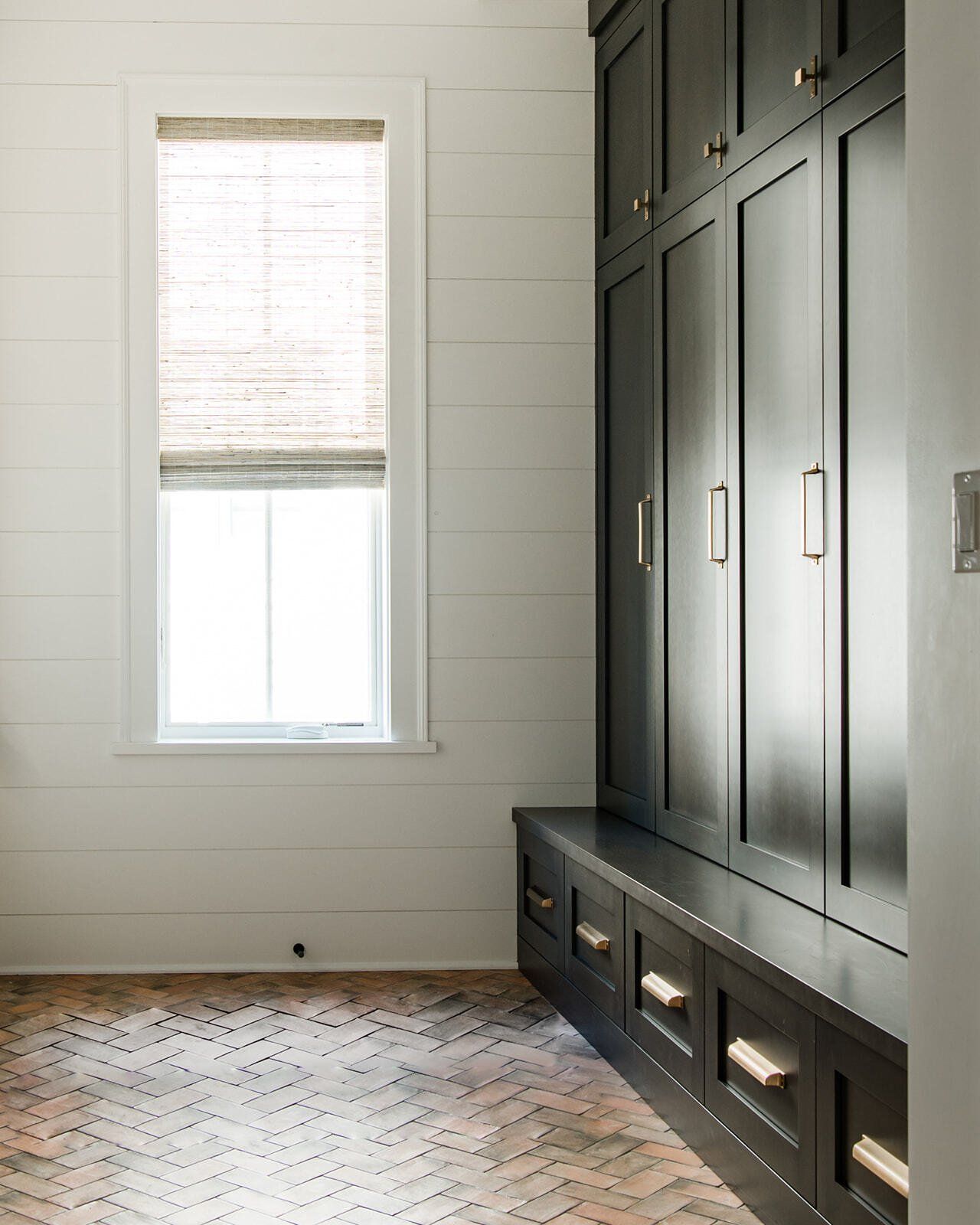 A room with black cabinets and a window.