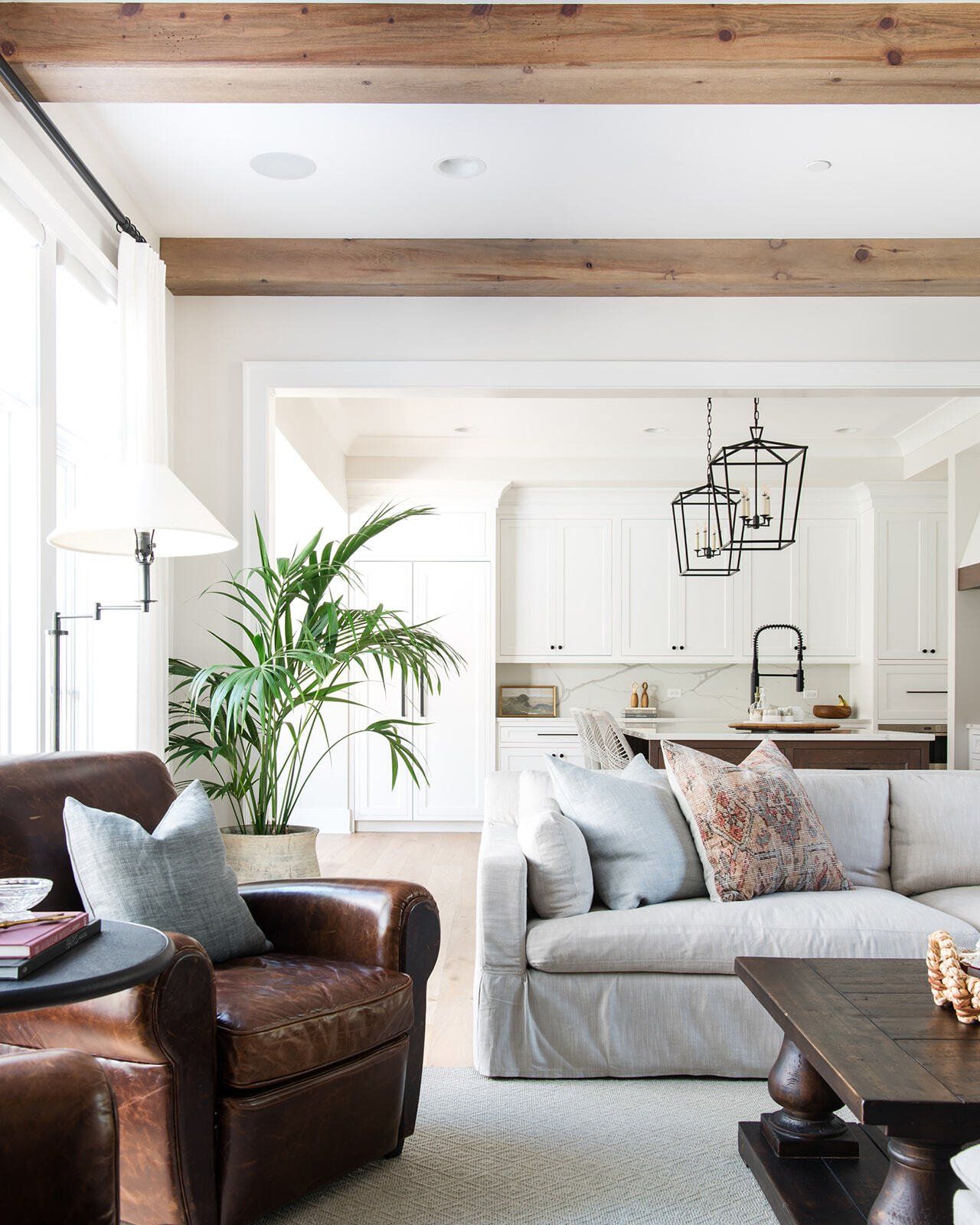A living room with a couch , chair and coffee table.