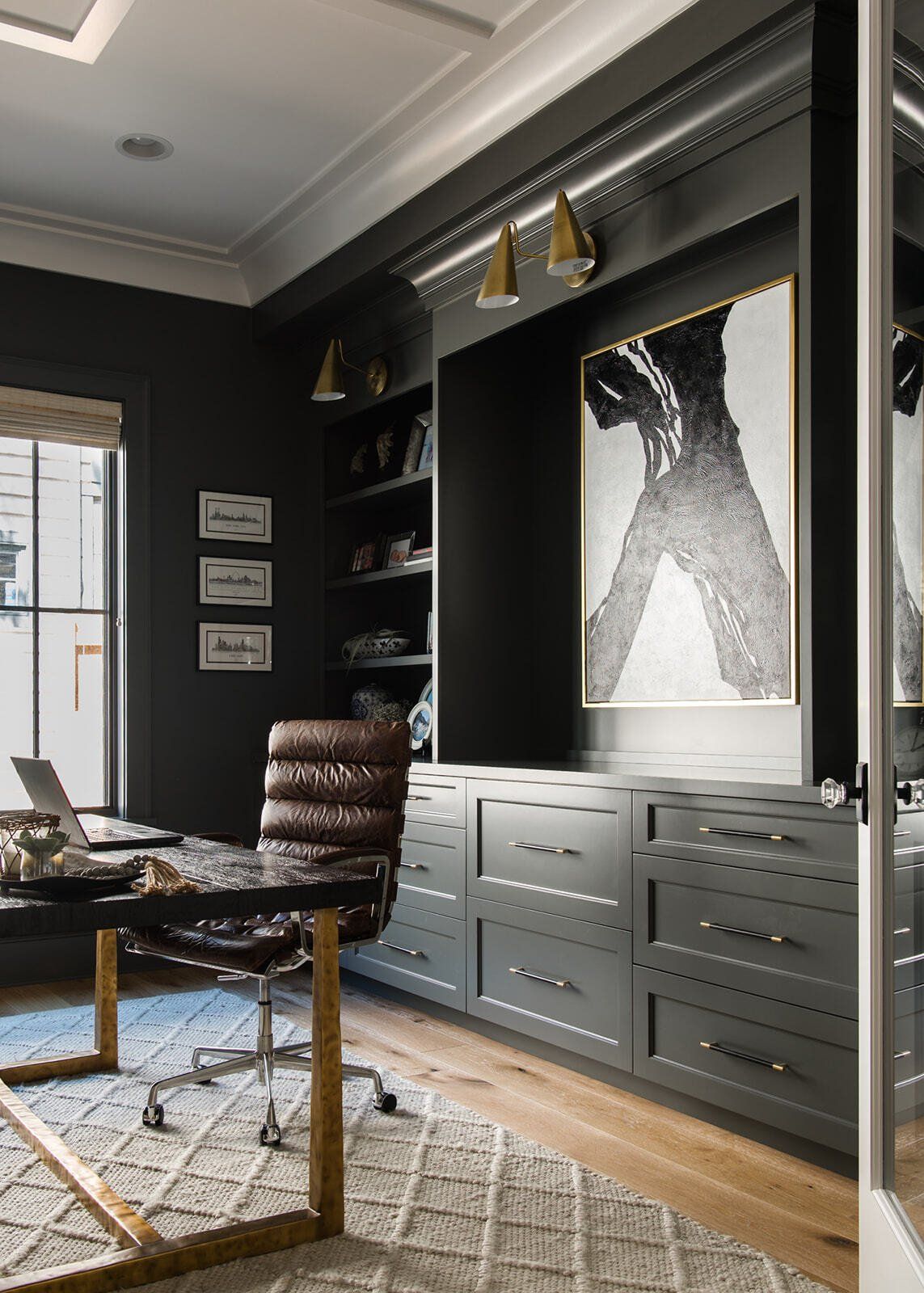 A home office with a desk , chair , and a laptop.