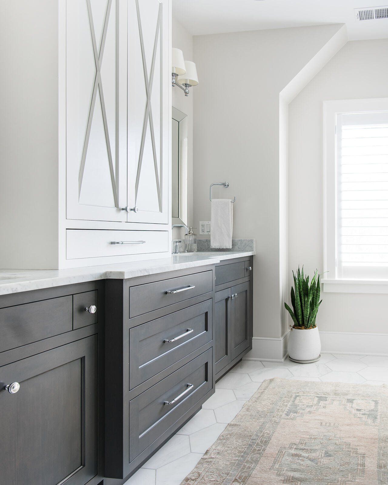 A bathroom with black cabinets and white counter tops