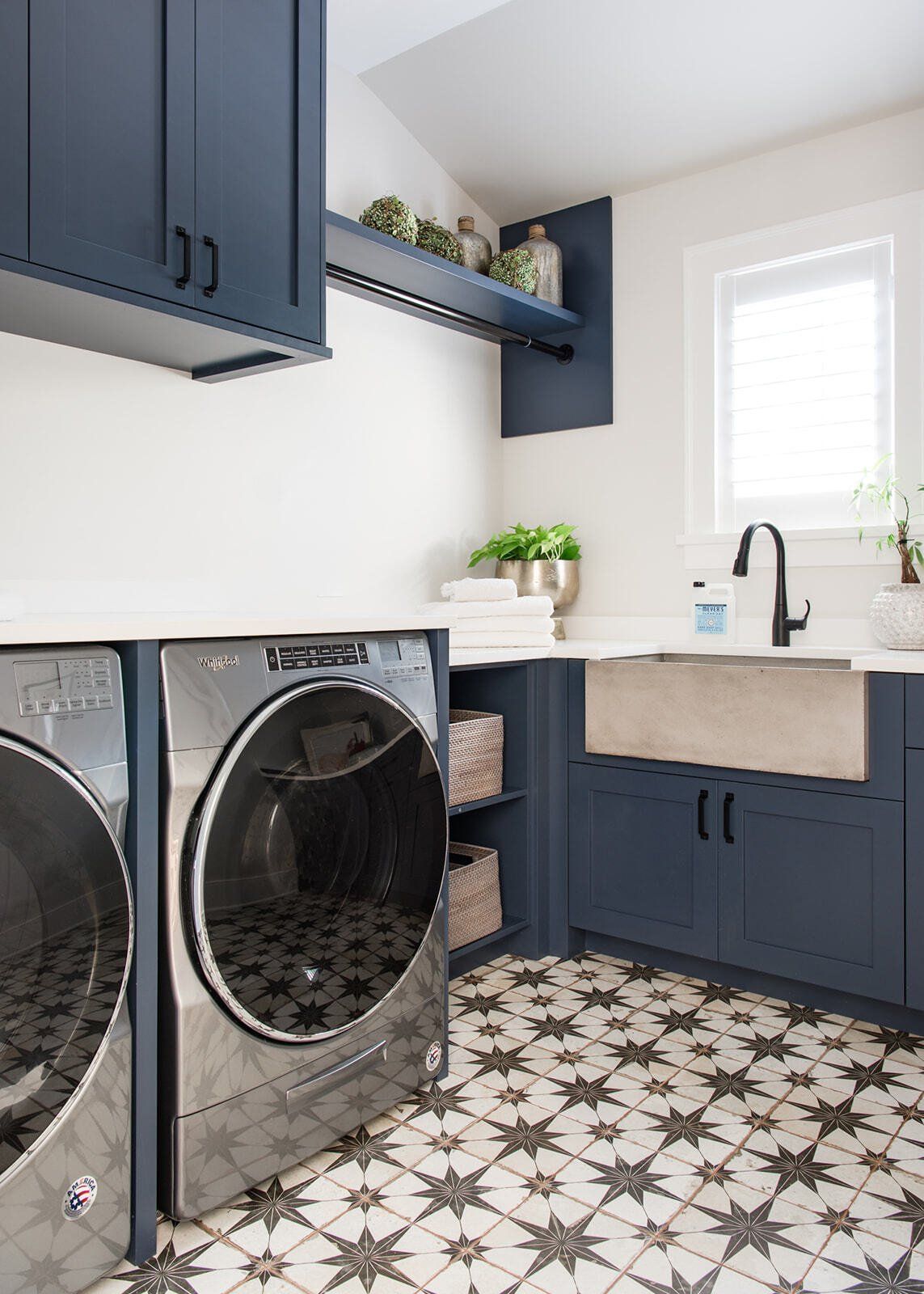 A laundry room with a washer and dryer and a sink.