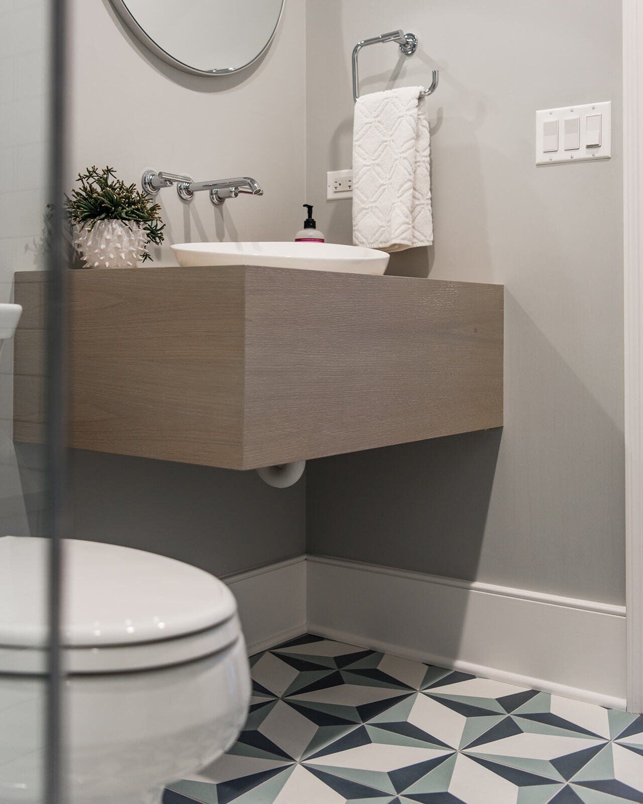 A bathroom with a toilet a sink and a mirror