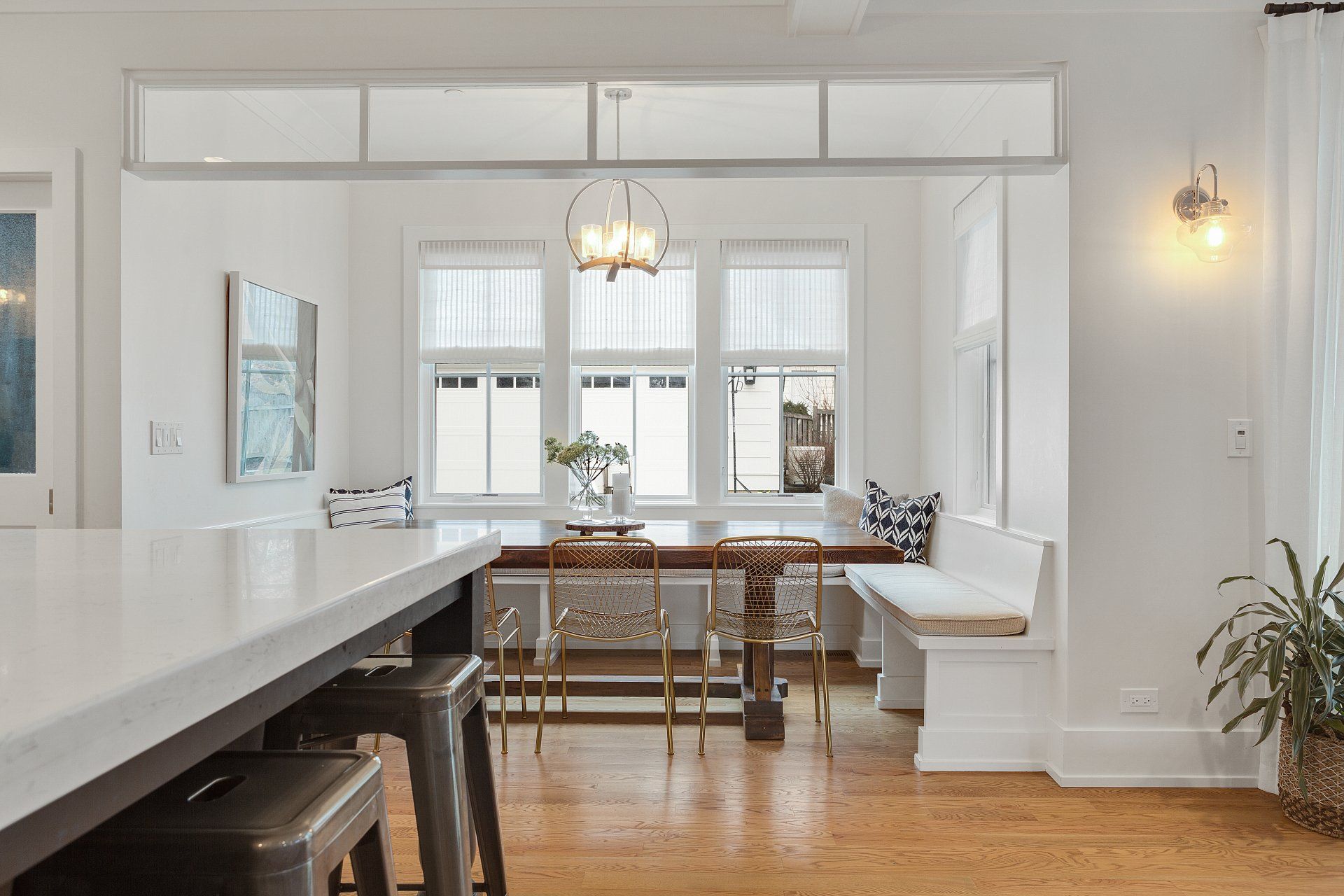 A kitchen with a table , chairs , and a bench.
