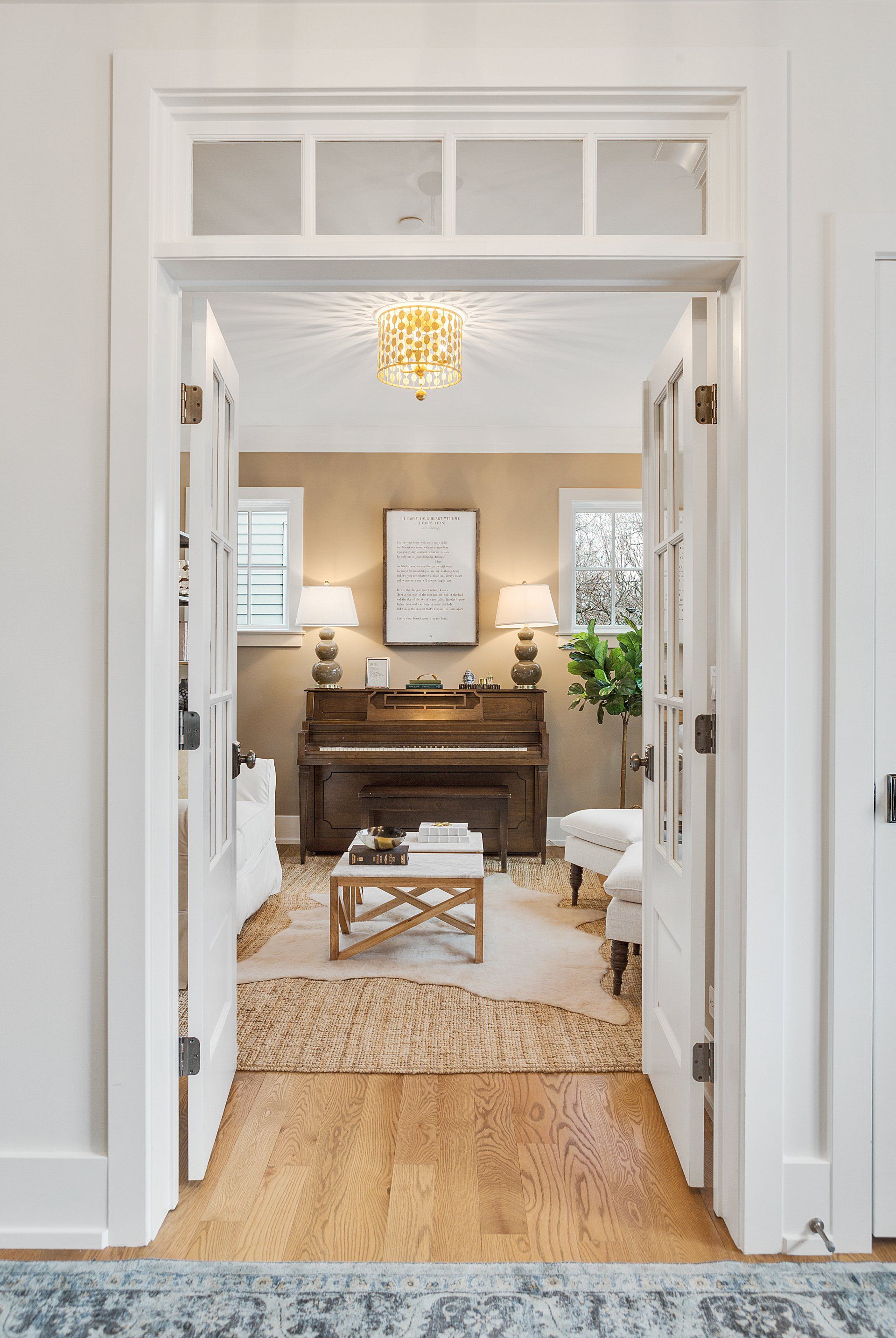 A living room with a piano and a coffee table.