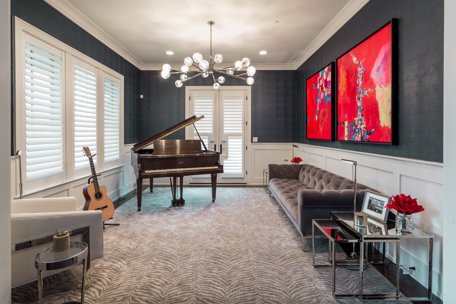 A living room with a piano , couch , and guitar.