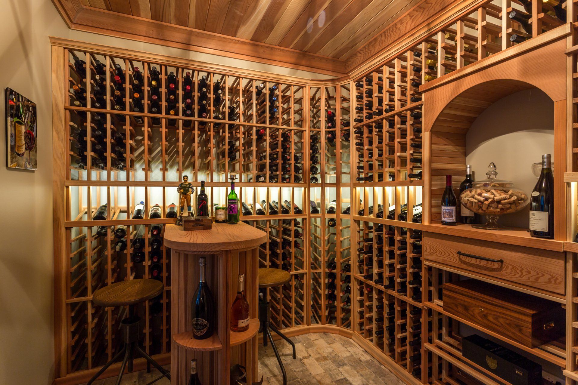 A wine cellar filled with lots of wine bottles and a table.