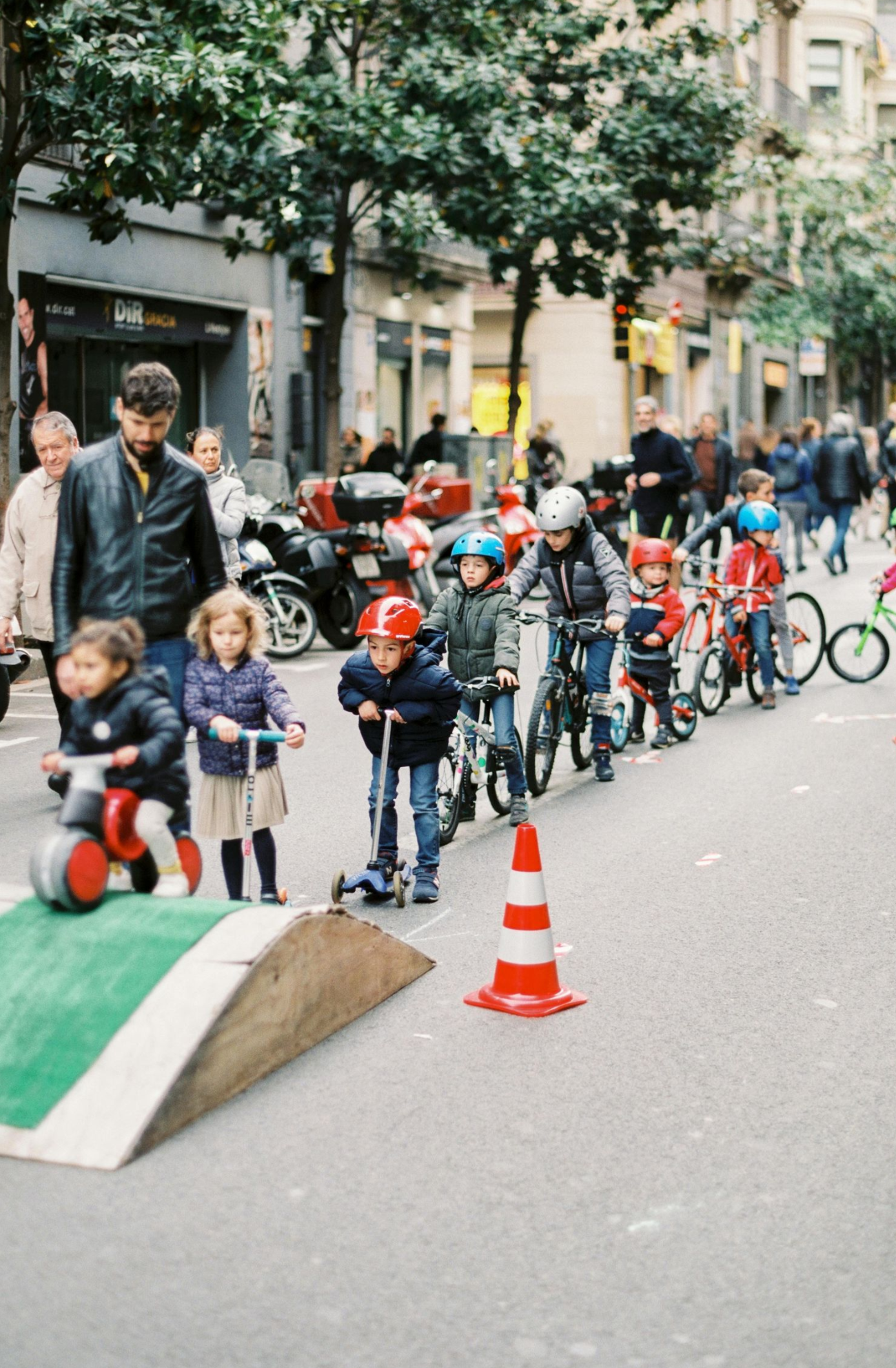 Parent helping their child ride a bike