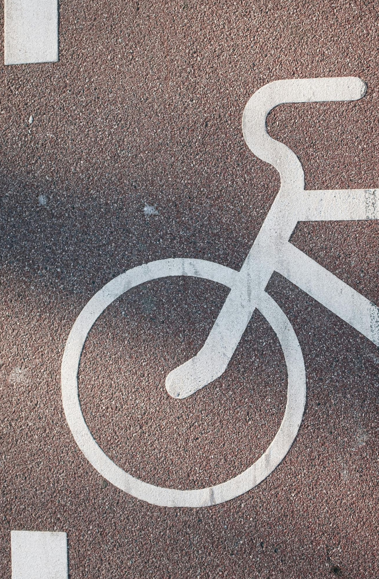 Parent helping their child ride a bike