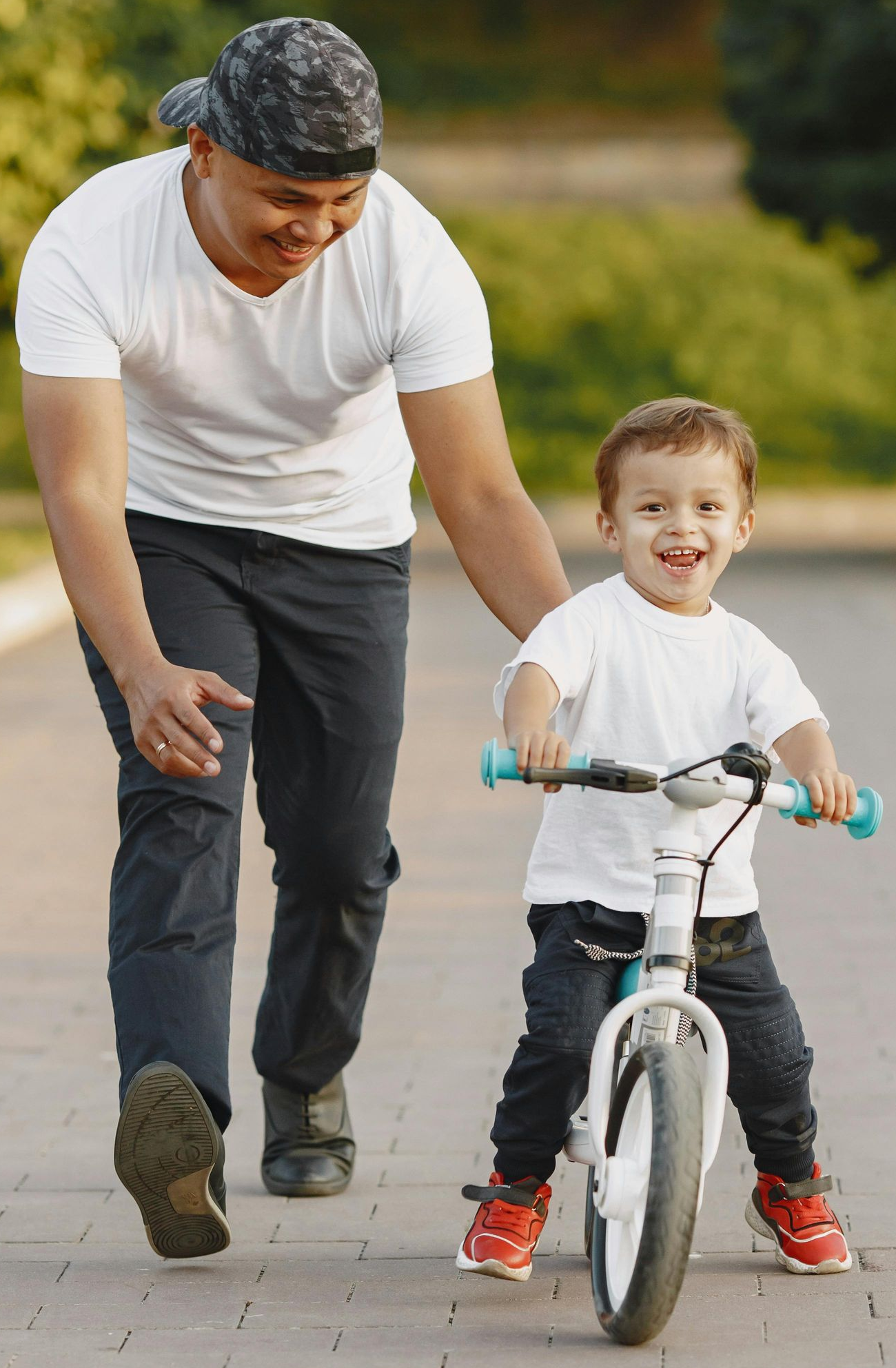 Parent helping their child ride a bike