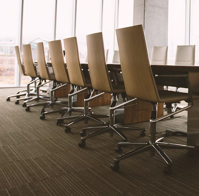 A conference room with a long table and chairs