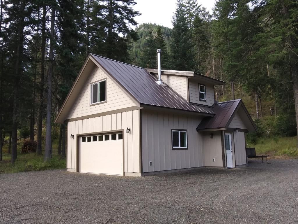 A house with a garage and a brown roof