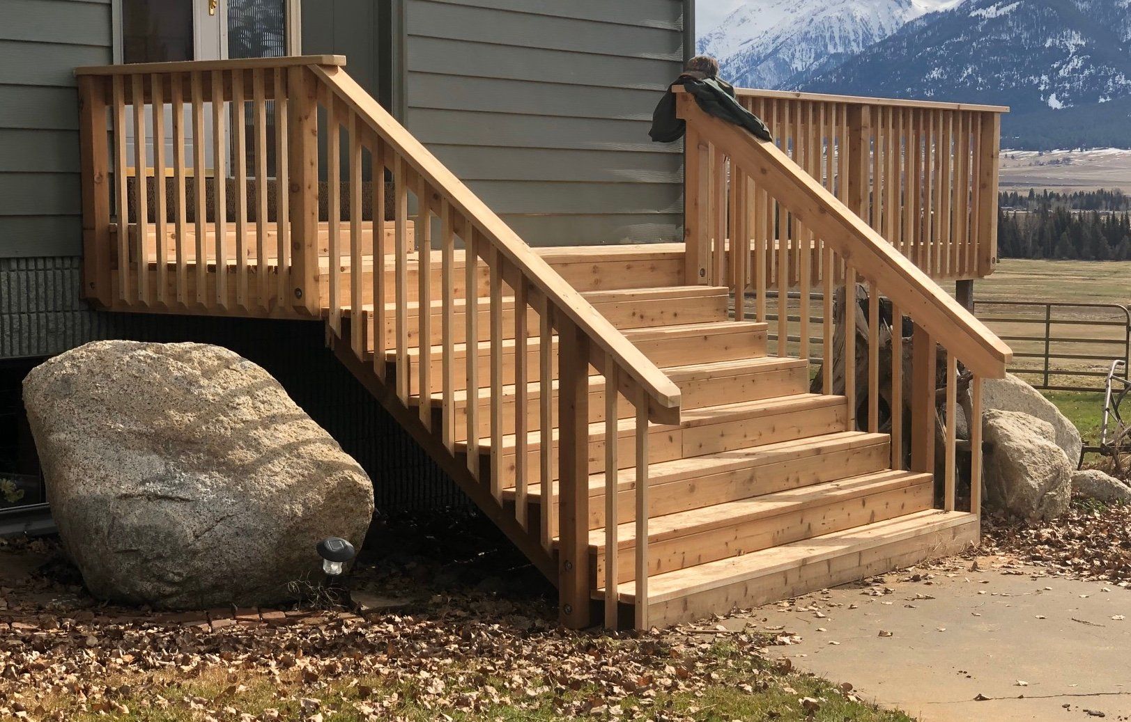 A wooden deck with stairs leading up to it