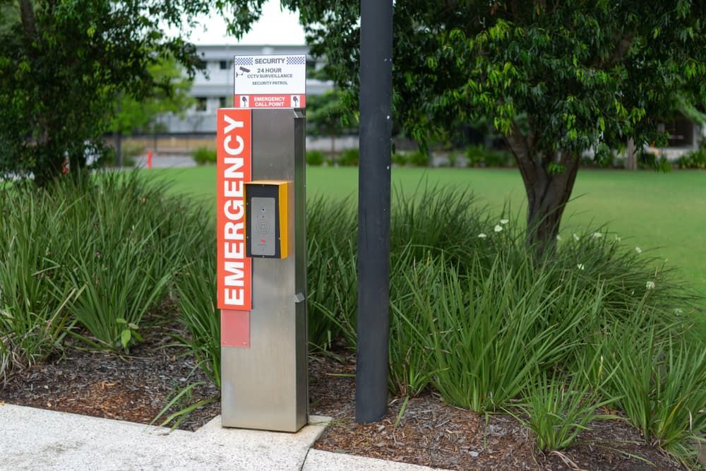 An Emergency Box is Sitting Next to a Tree in a Park — BNCC Security Services in Port Macquarie, NSW