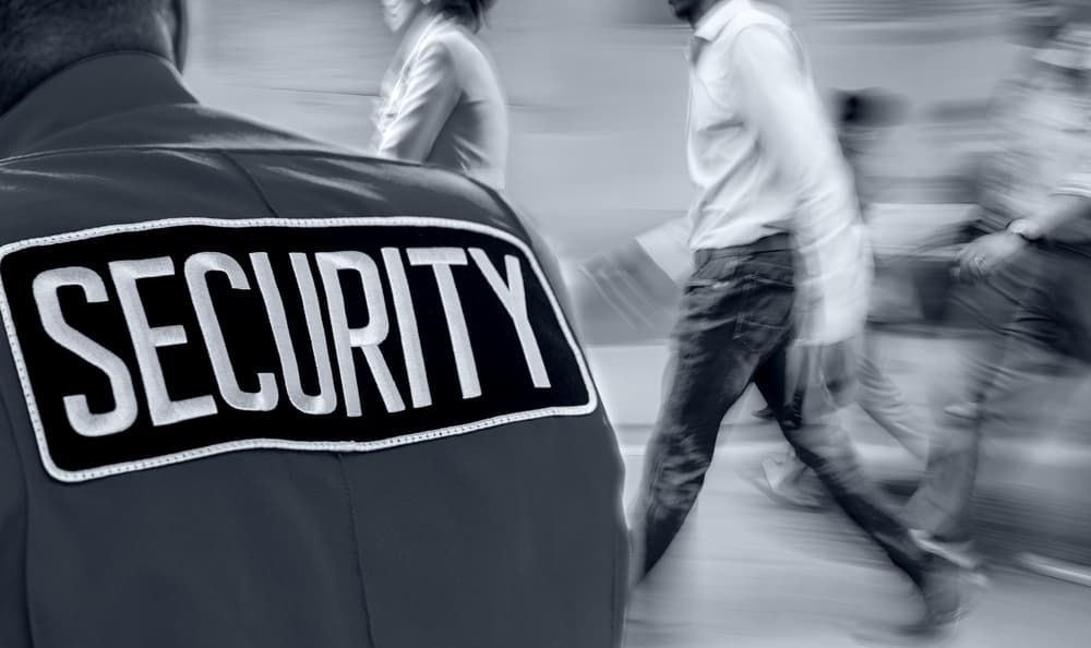 A Security Guard is Standing in Front of a Crowd of People — BNCC Security Services in Port Macquarie, NSW