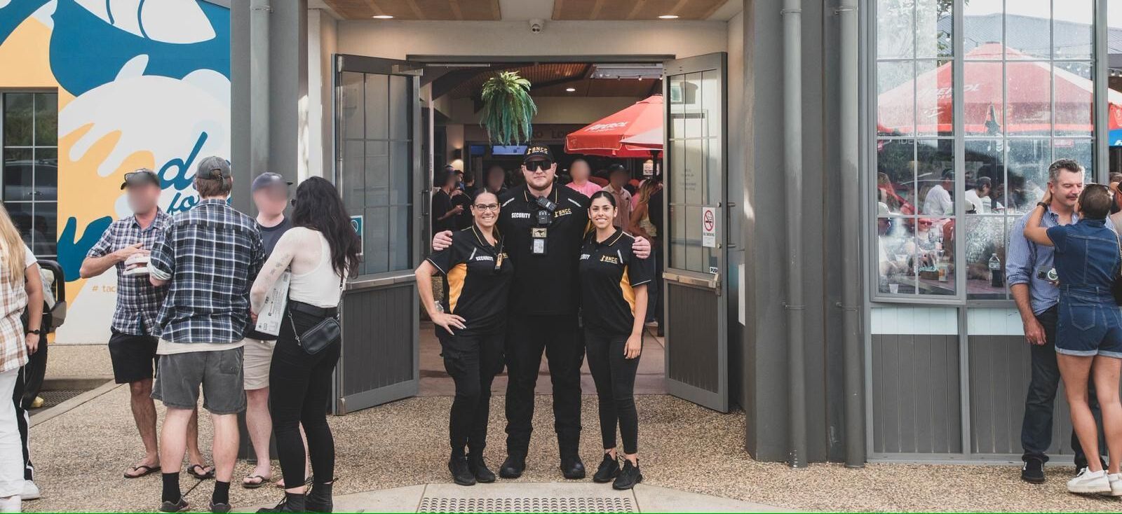 A Security Guard is Covering His Ears With His Hands in a Nightclub — BNCC Security Services in Port Macquarie, NSW 