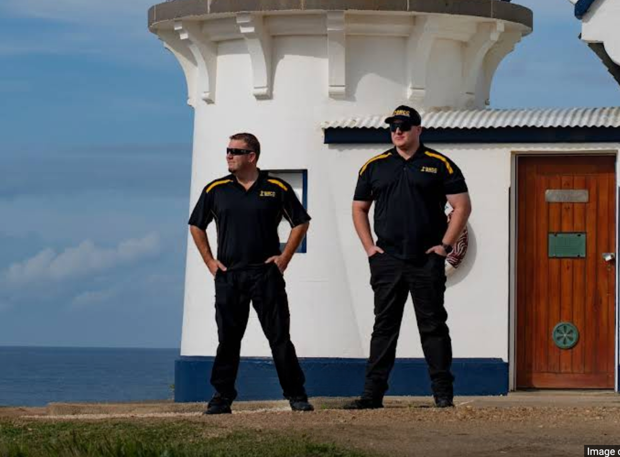 Two Security Guards Are Standing Next to a Security Vehicle — BNCC Security Services in Port Macquarie, NSW