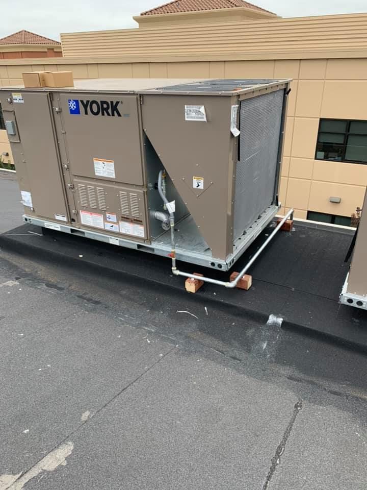 A york air conditioner is sitting on top of a roof.