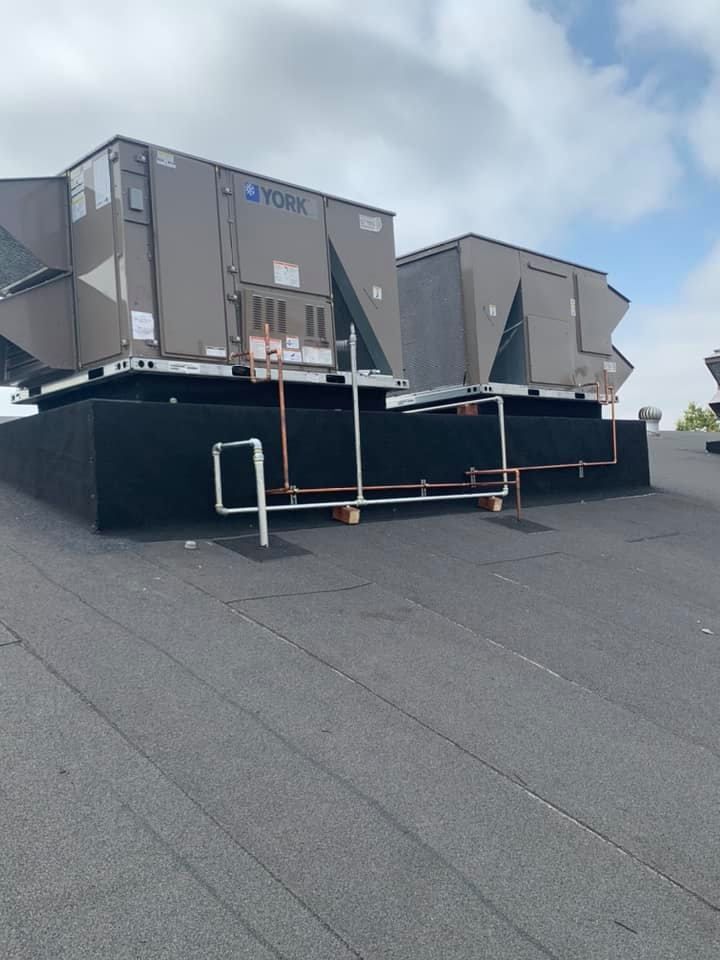 A york air conditioner is sitting on top of a roof