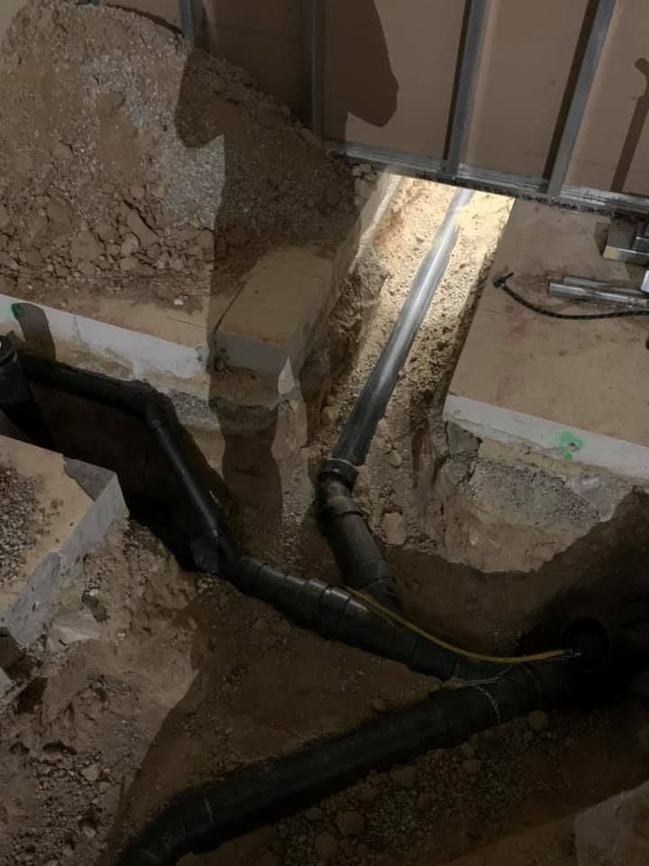 A bunch of pipes are being installed in a hole in the ground.