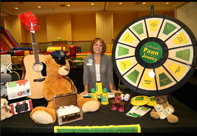 Colorado Pawn's Evie K and her wheel of fortune with all of the prizes to win