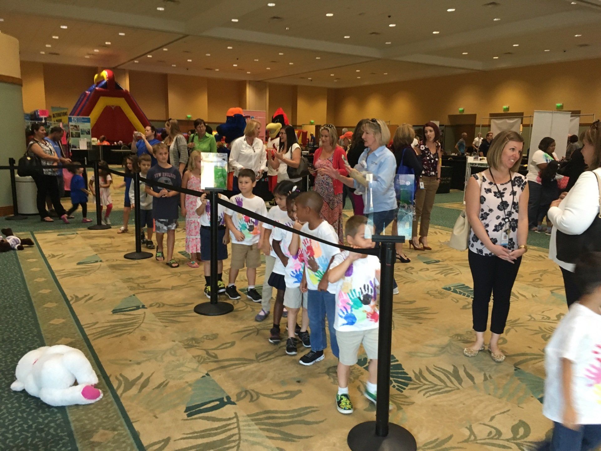 Children lining up to donate their new stuffed teddy bear to the Buddy Bear® bin