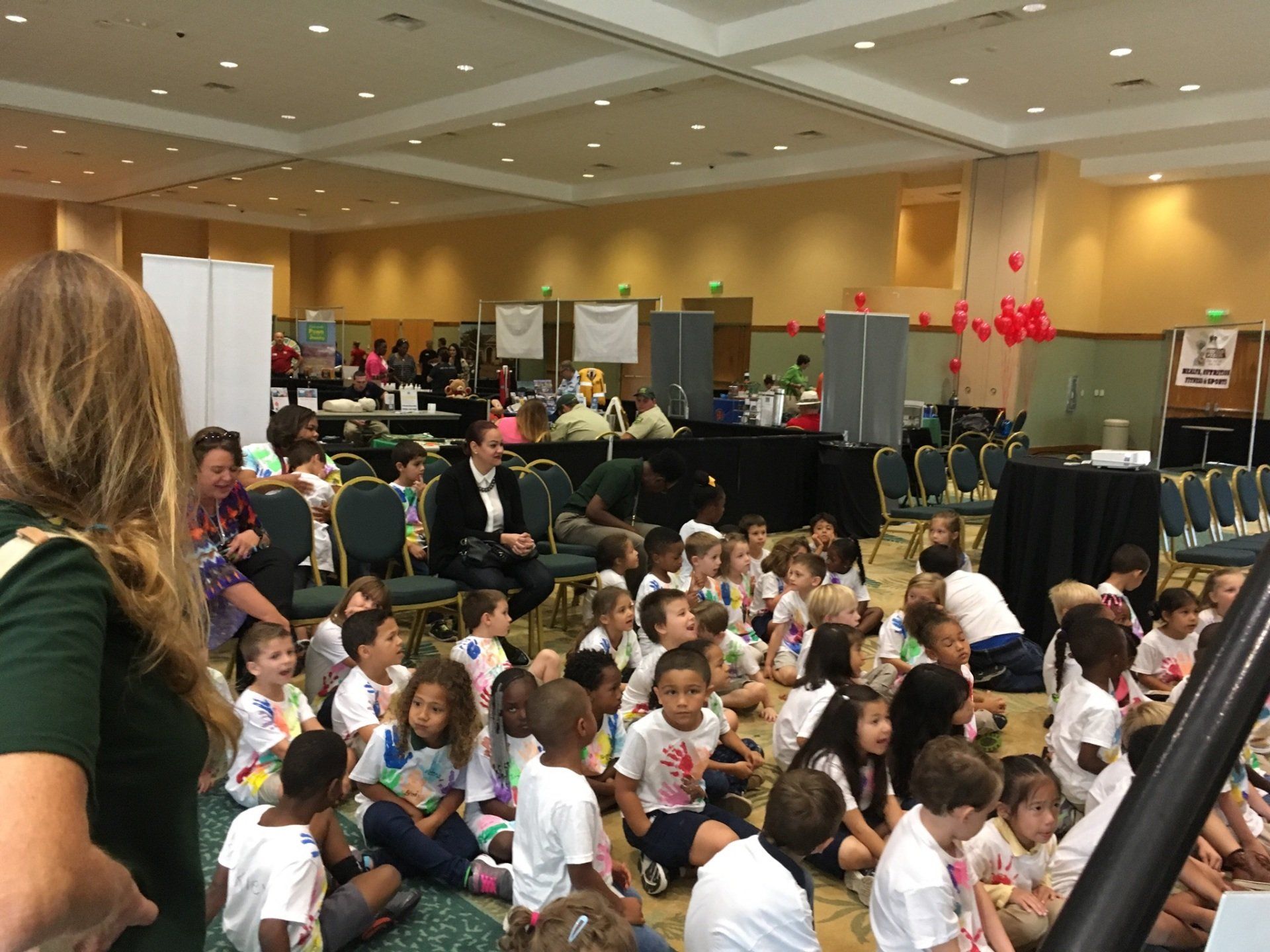 Children getting ready to hear and see a new story from one of the National Authors at the Buddy Bear® Den's Main Stage!