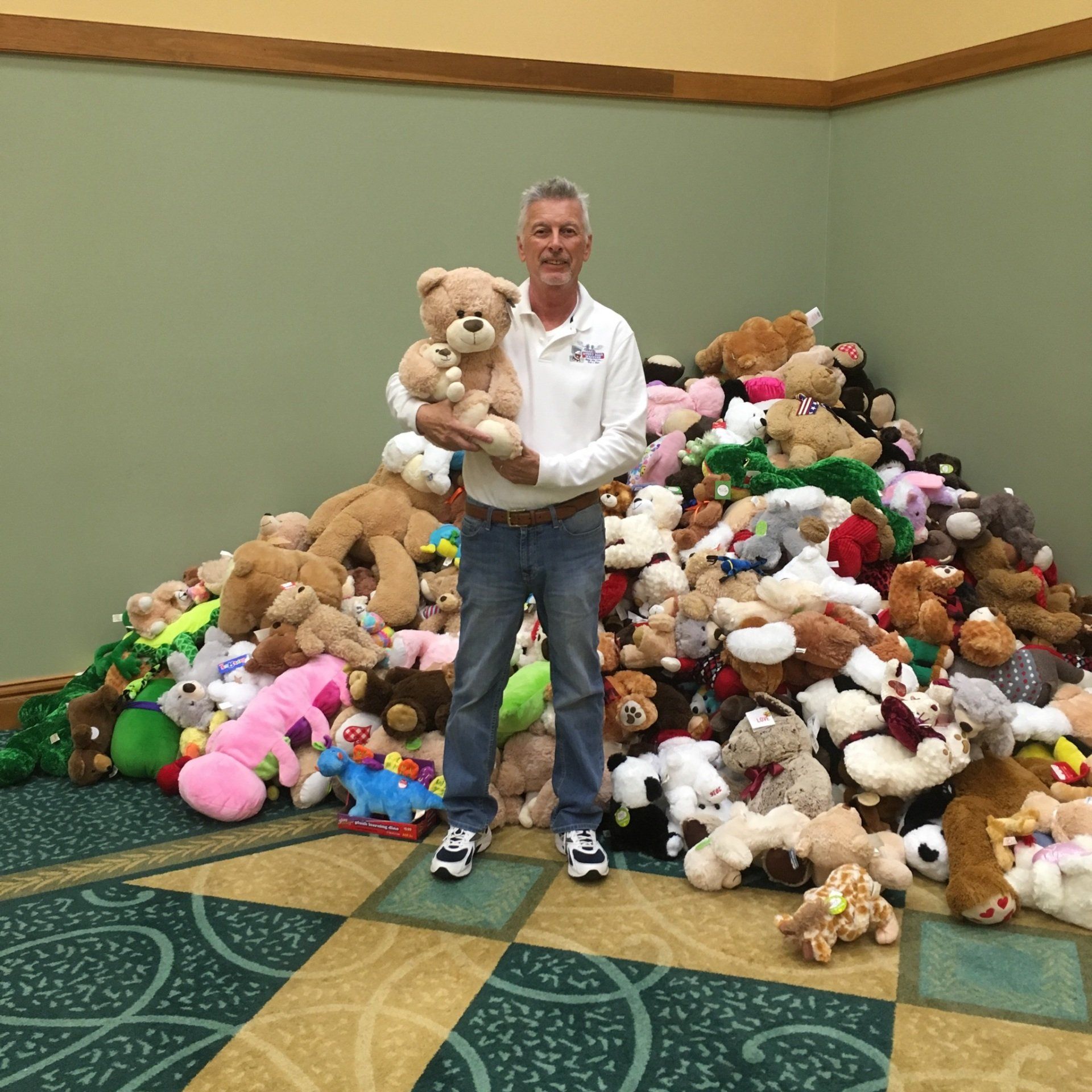 A 12 foot high wall behind the founder with over 2500 teddy bears